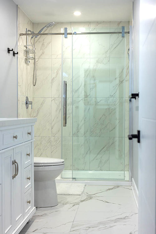 shower space with white vanity and counter top and toilet