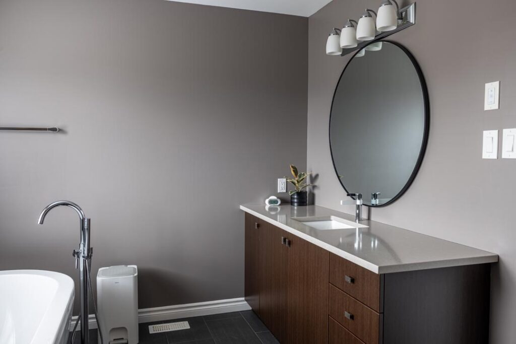painted walls with large mirror and wooden vanity