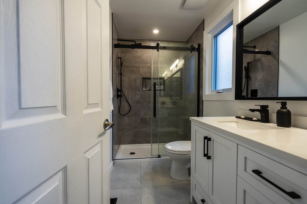 marble shower wall with white vanity