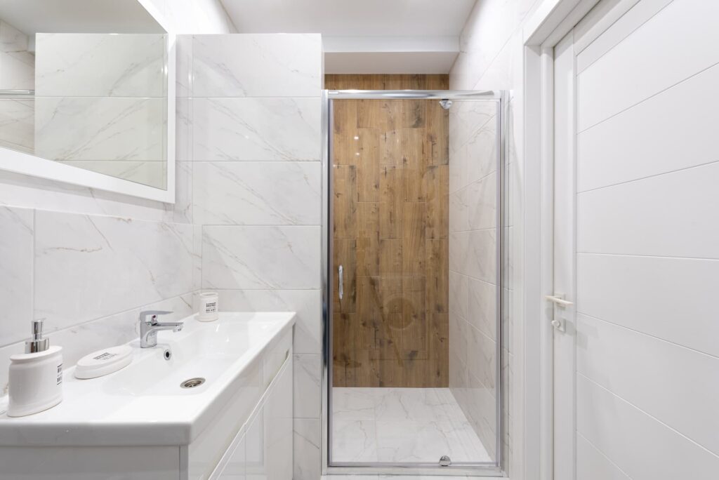 transparent grass shower door with ceramic counter top and vanity