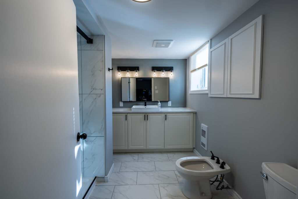 basement bathroom renovation with toilet and vanity 