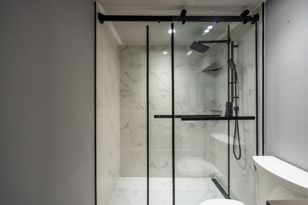 grey and black themed modern bathroom including shower room with vanity and toilet