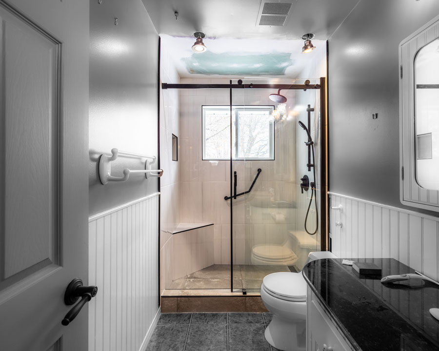 marble countertop with sliding shower door and lightning