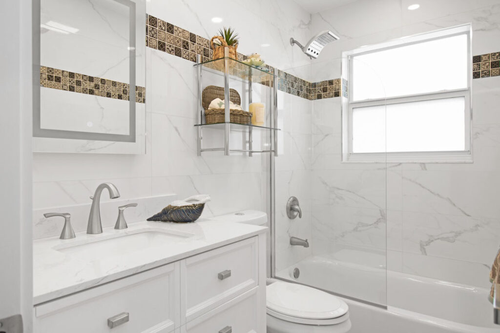 white tiled walls with white vanity and wallmount