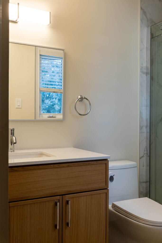 Wood-grain bathroom vanity with quartz countertop installed by iBathrooms in Ottawa