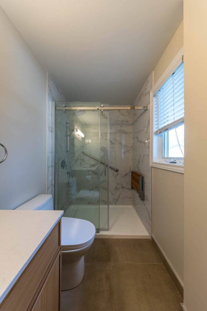 OVE shower with Moen fold-down shower seat and grab bar in Barrhaven bathroom