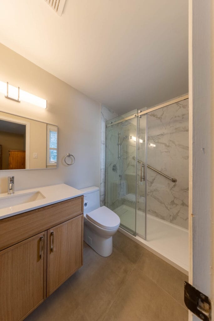 OVE sliding glass shower enclosure with rain head and handheld shower in Ottawa bathroom
